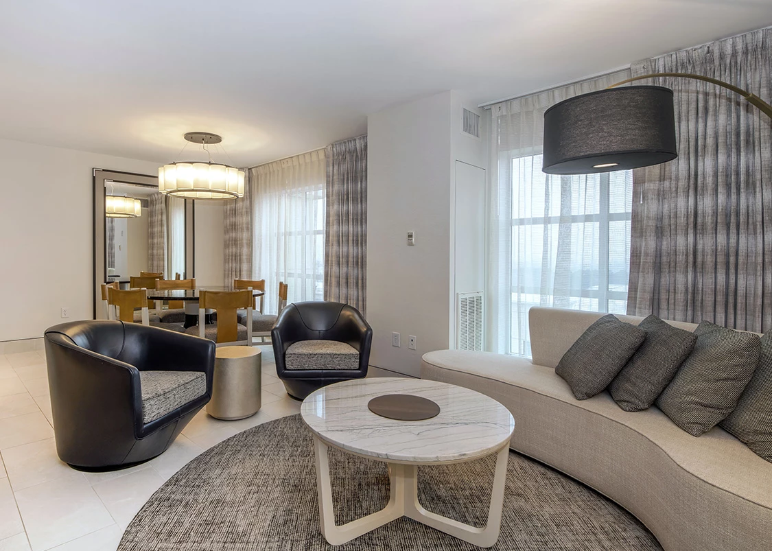 a hotel living room with a couch and a table