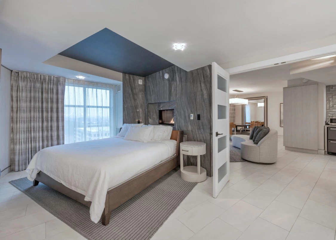 a hotel bedroom with a fireplace and a bed