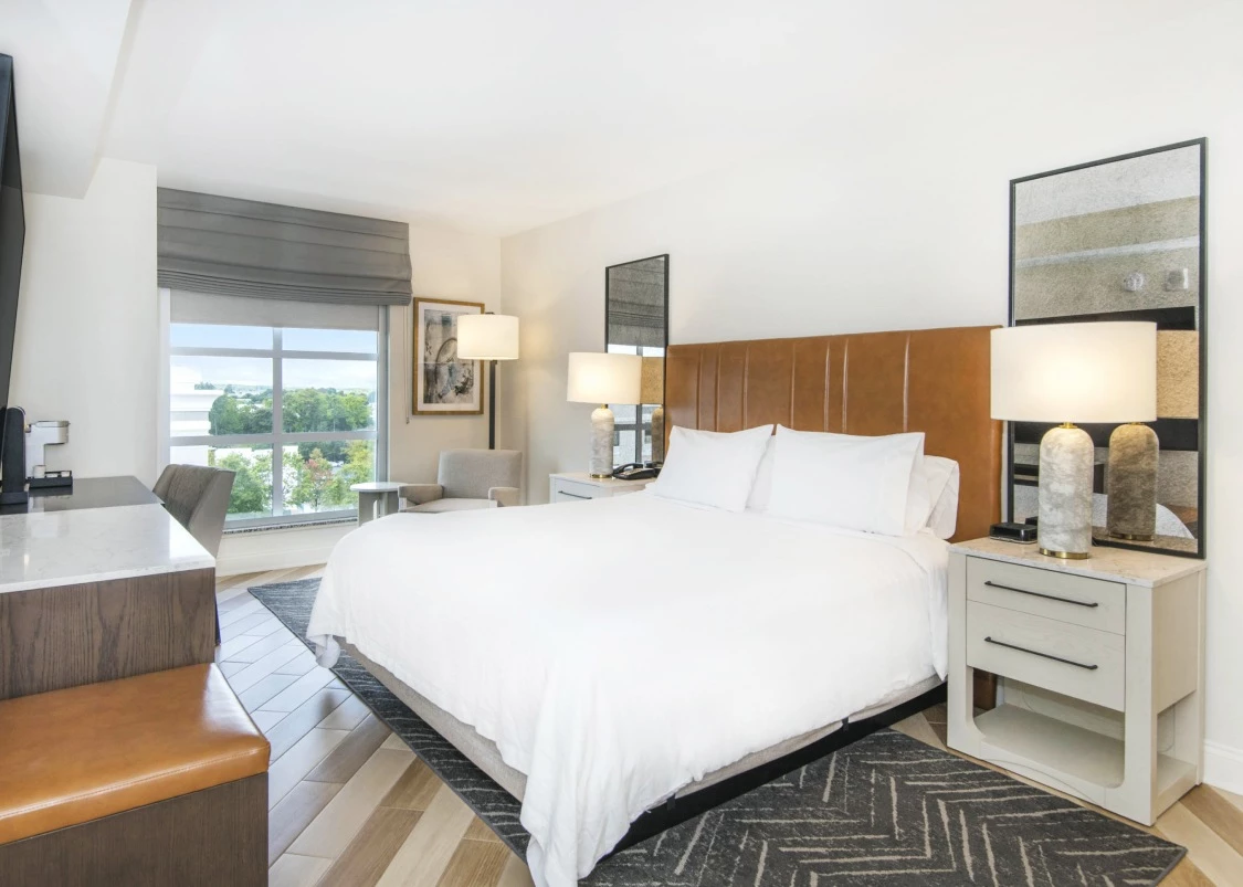 a hotel bedroom with a bed and a table