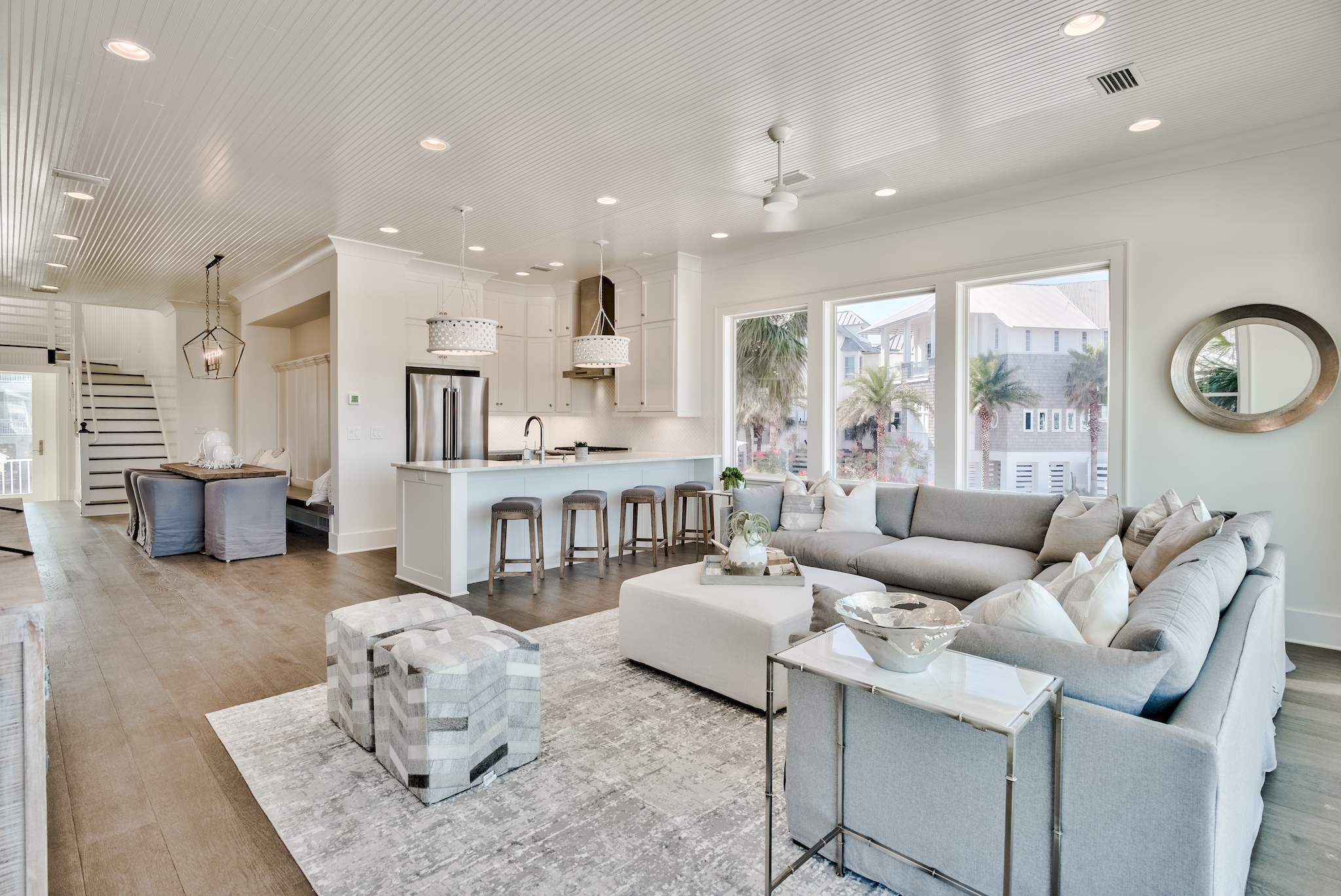 a living room with a large couch and a kitchen