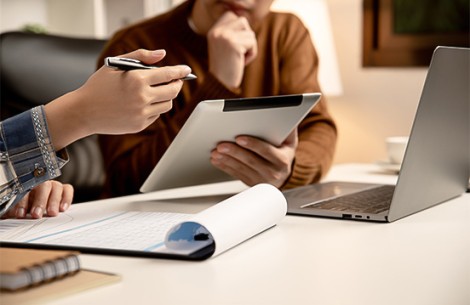 a person holding a tablet and a pen