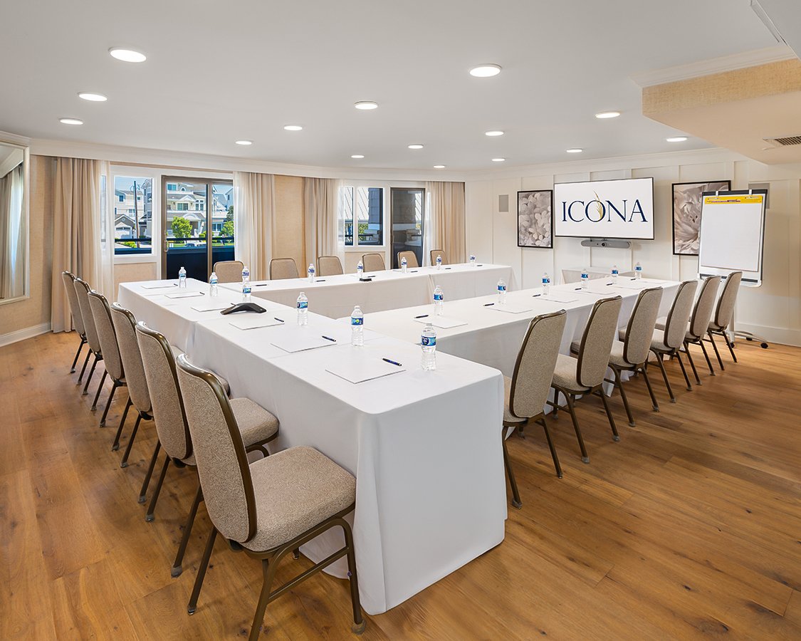 a room with a long table and chairs