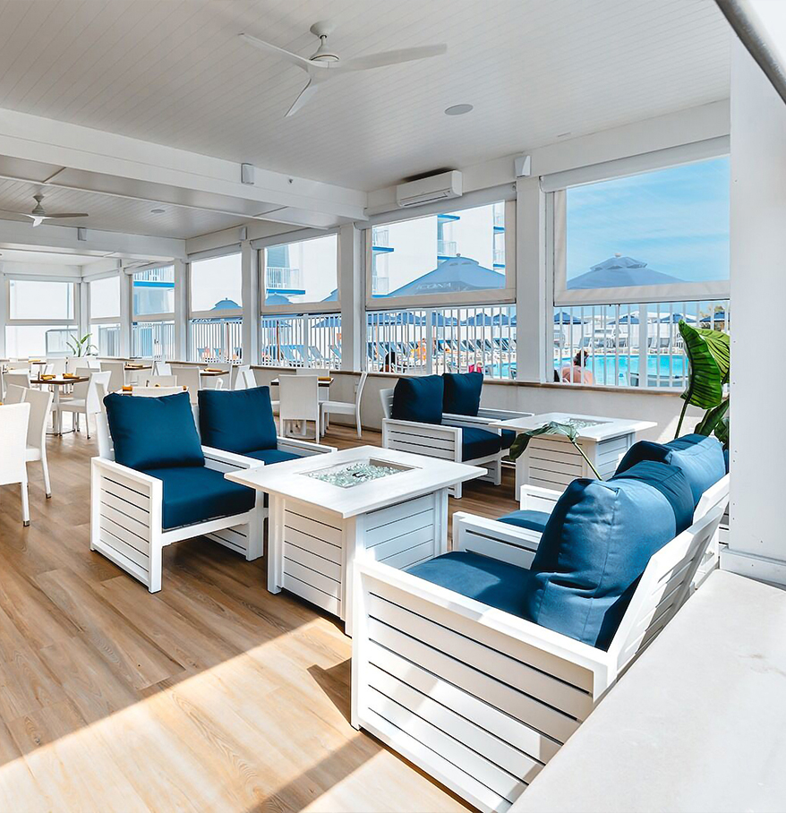 a room with white furniture and blue chairs