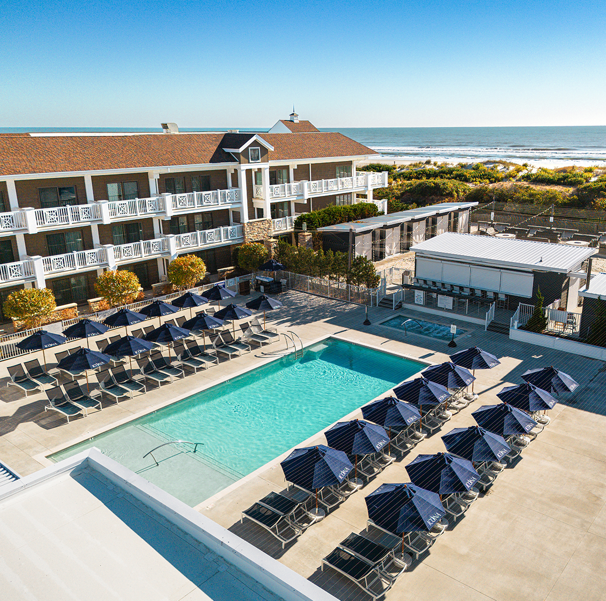 a pool with umbrellas and chairs in a hotel