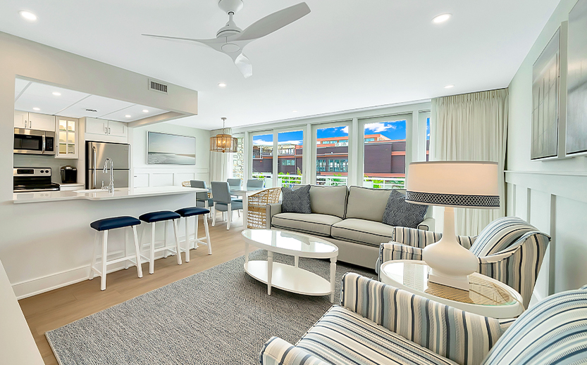 a living room with a couch and a kitchen