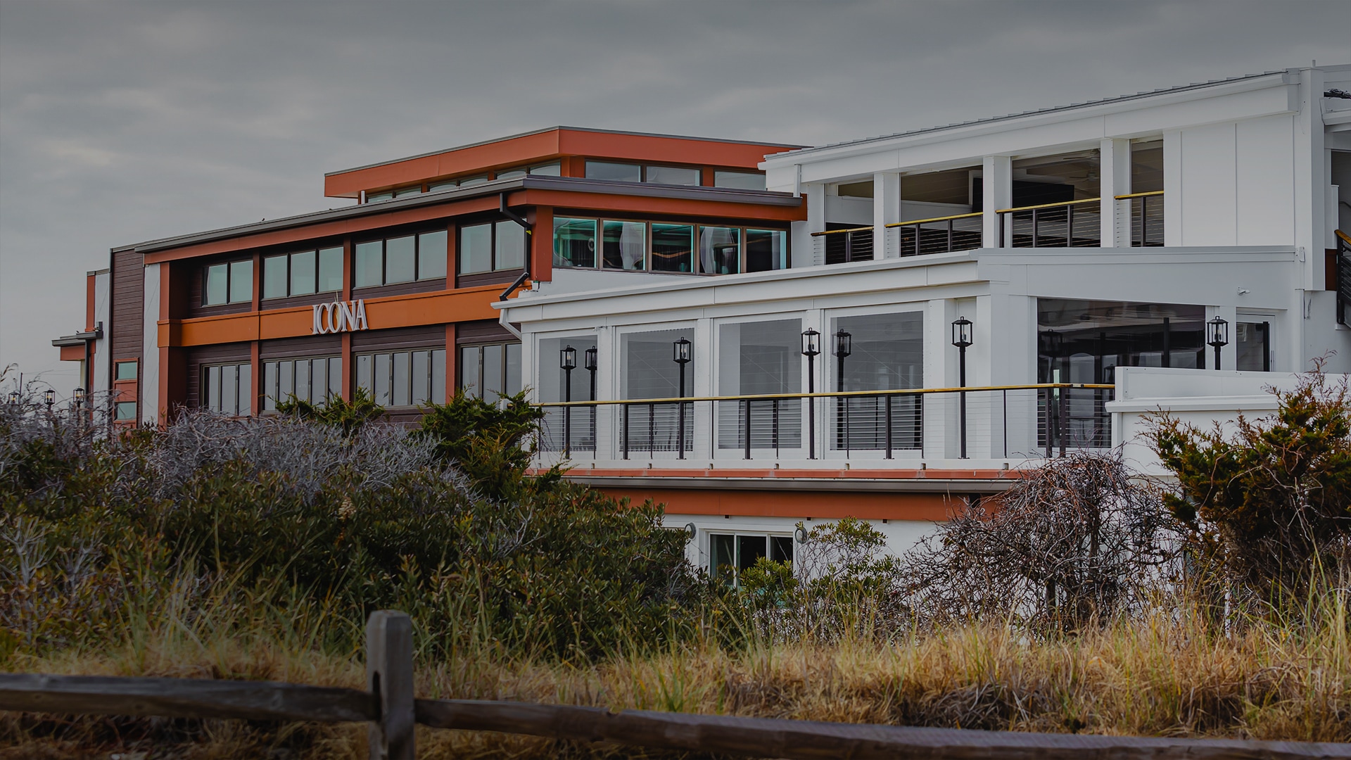 a building with a balcony and a fence