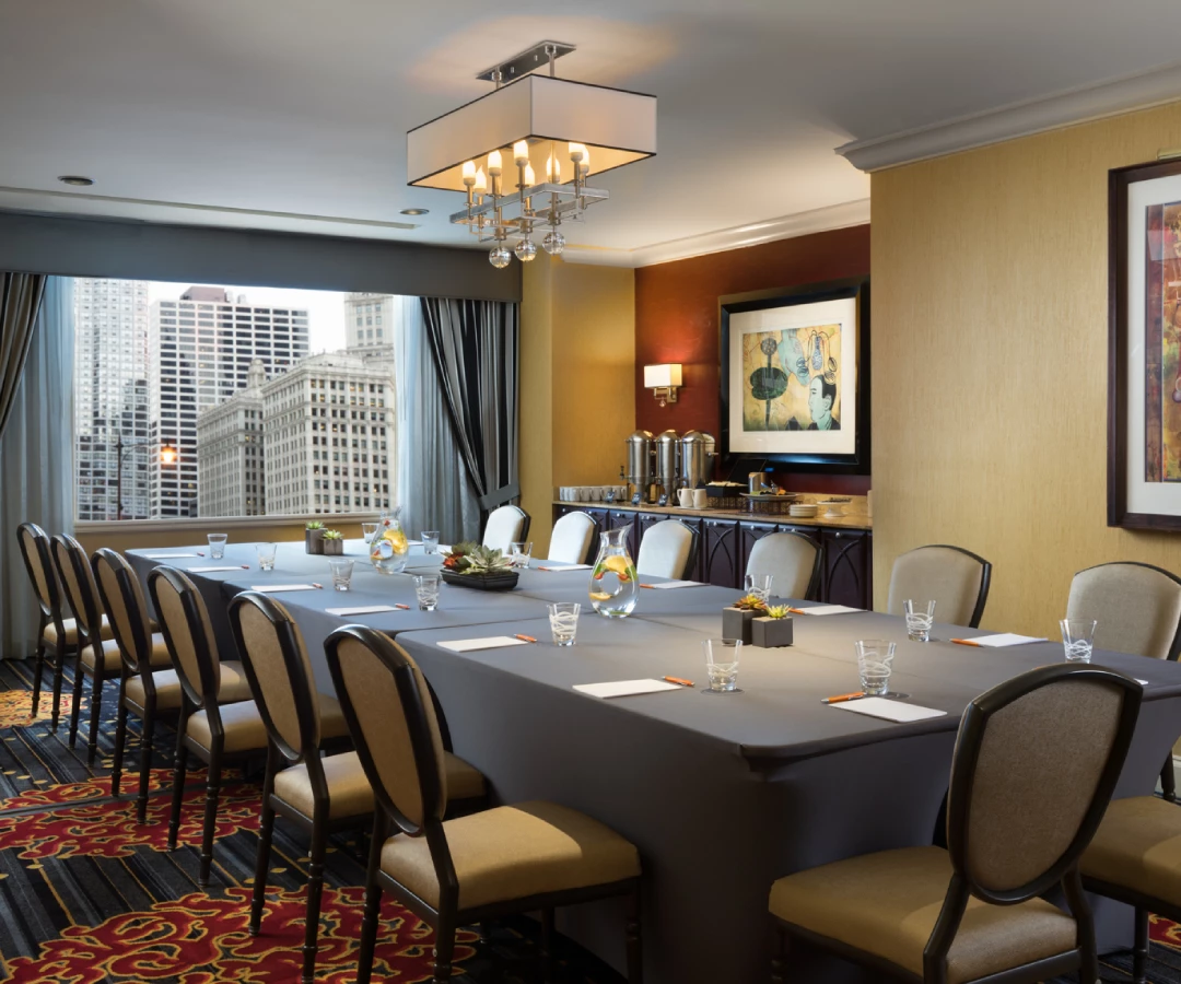 a meeting room with a large table by the window