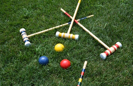croquet mallets and balls on grass