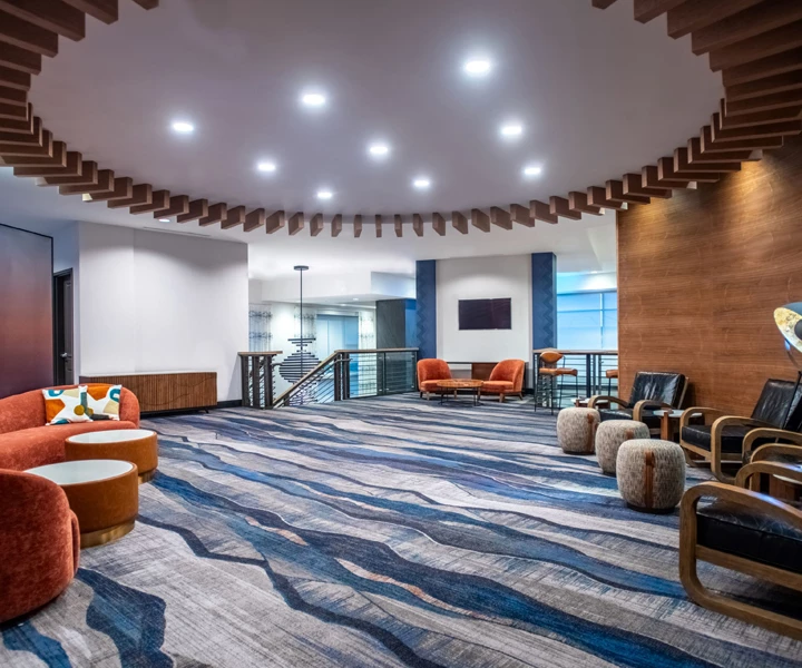 a room with a large blue rug and a large pool table