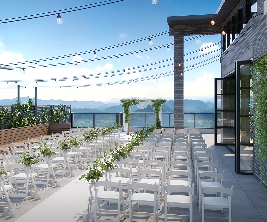 ceremony setup on rooftop with white chairs overlooking the mountains