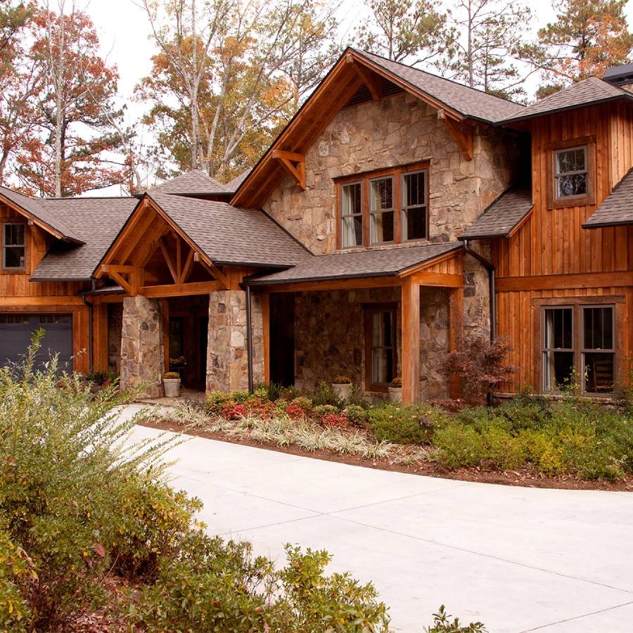 a house with a driveway and trees