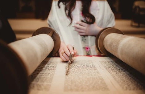 a person holding a pen over a book