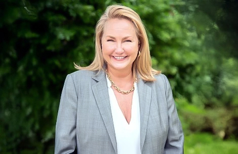 a woman in a suit smiling