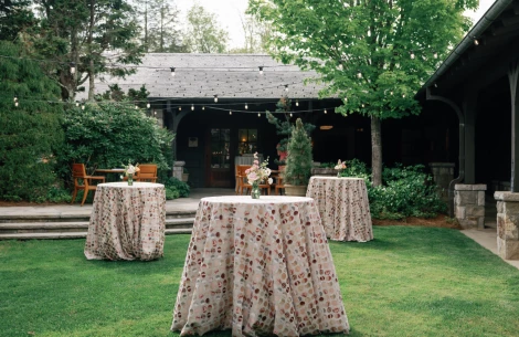 a table covered in cloth with flowers on it