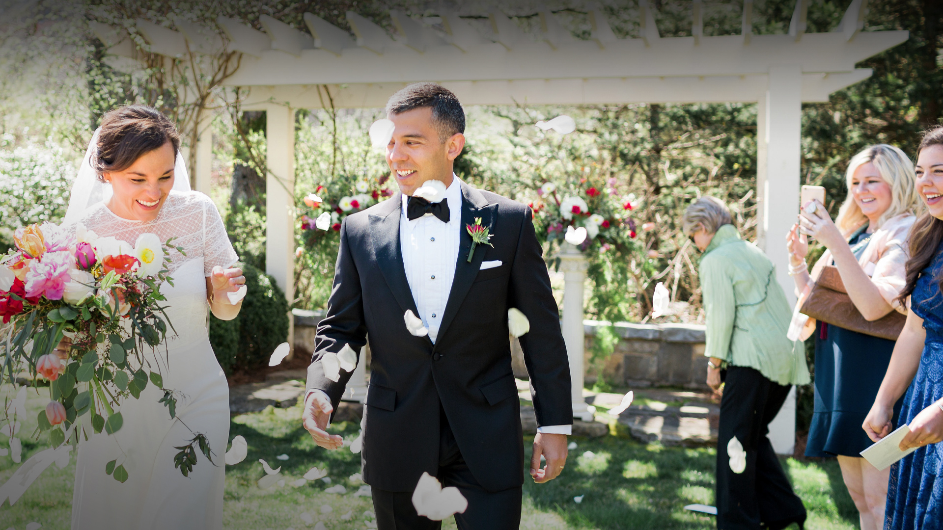 a man in a suit throwing petals