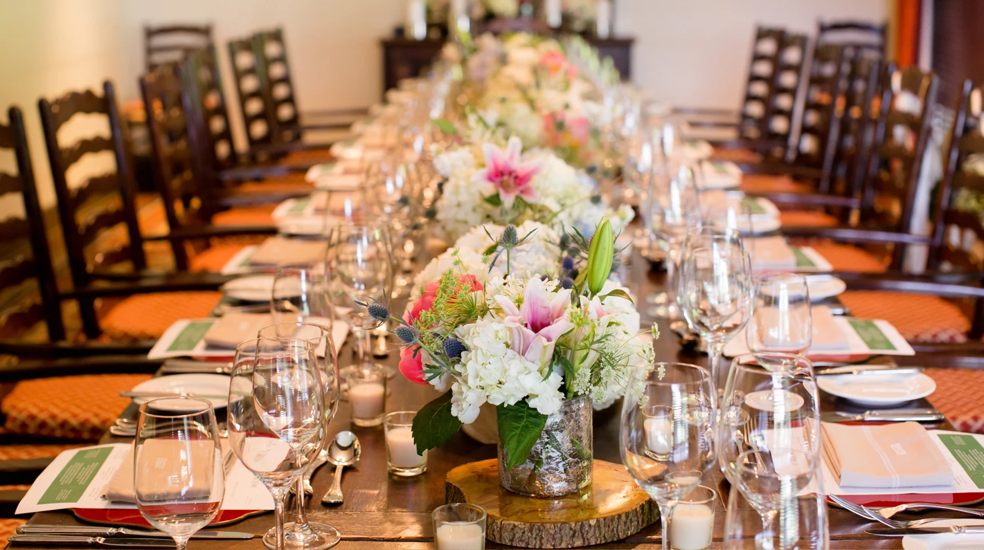 a long table with flowers and candles