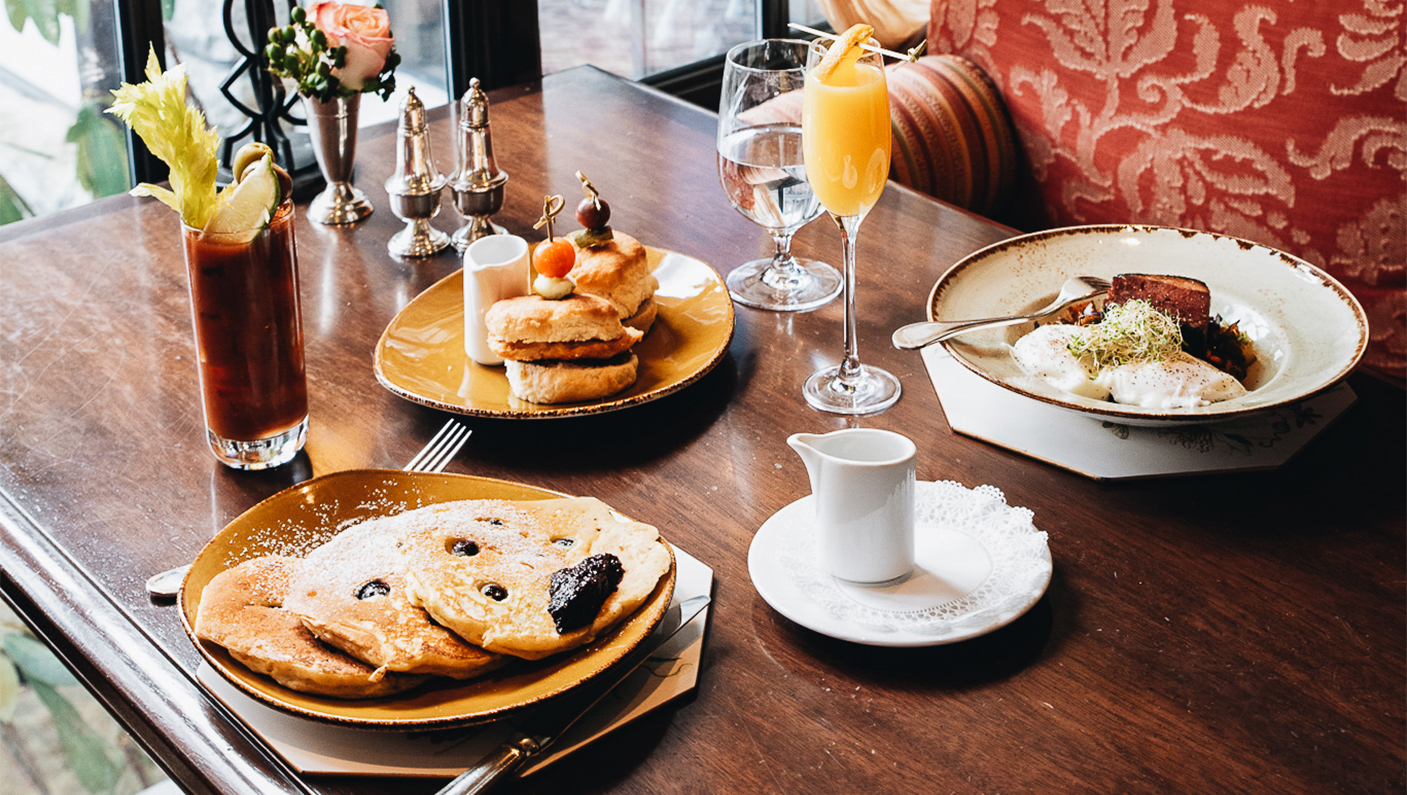 a table with plates of food and drinks