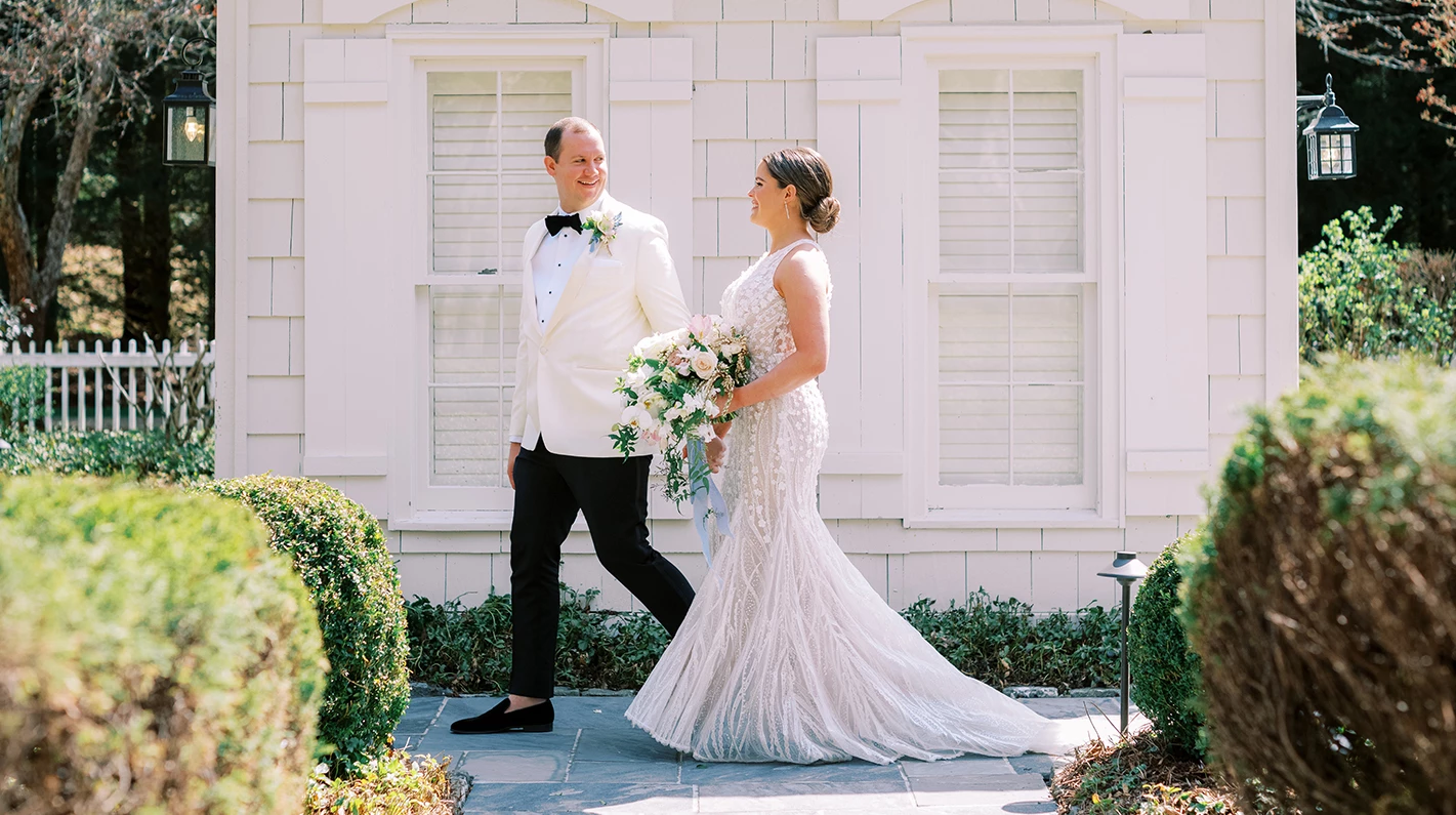 a man and woman in a white suit