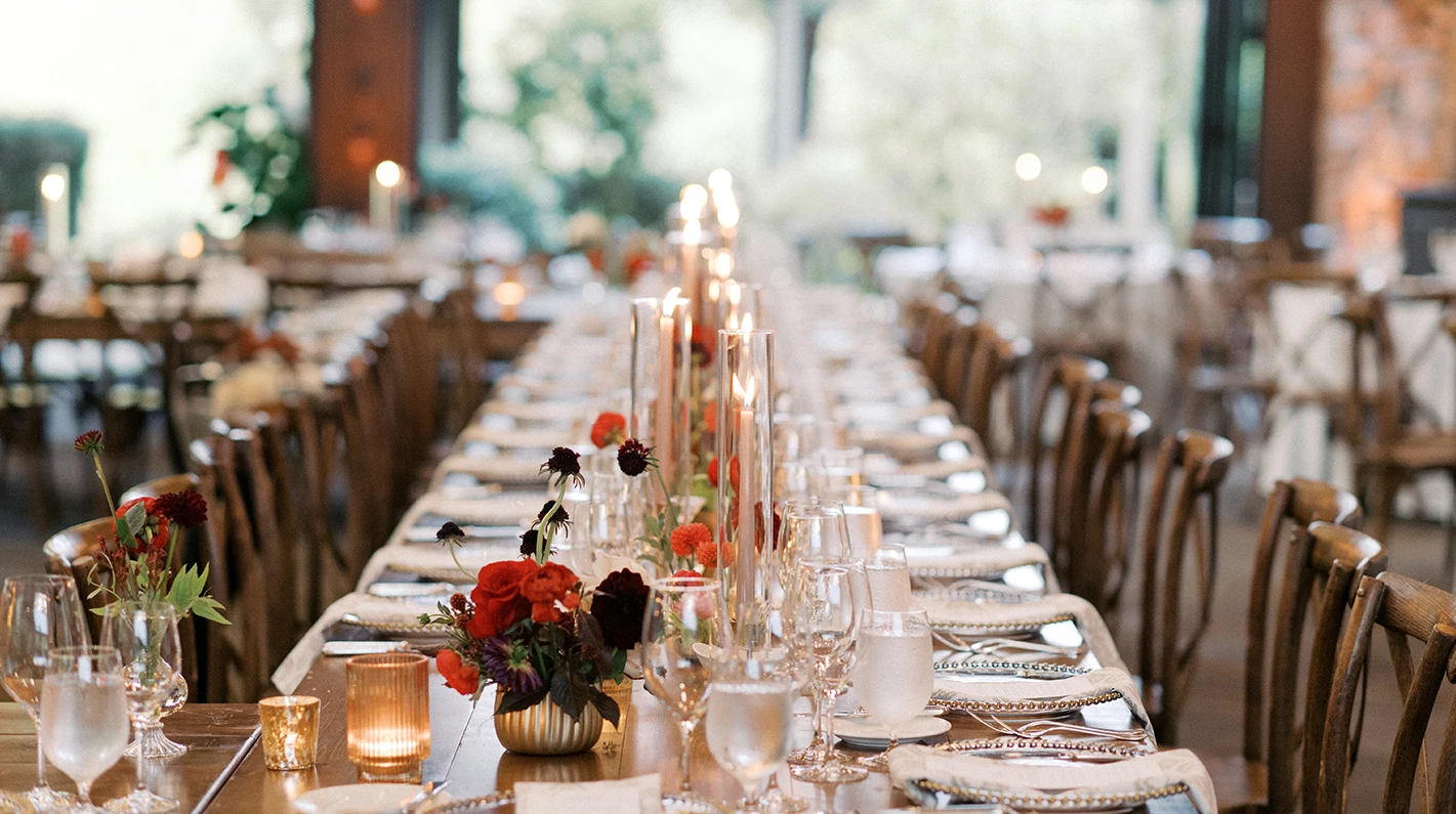 a long table with candles and flowers