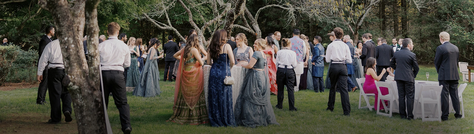 a group of women in formal dresses standing in a line outside