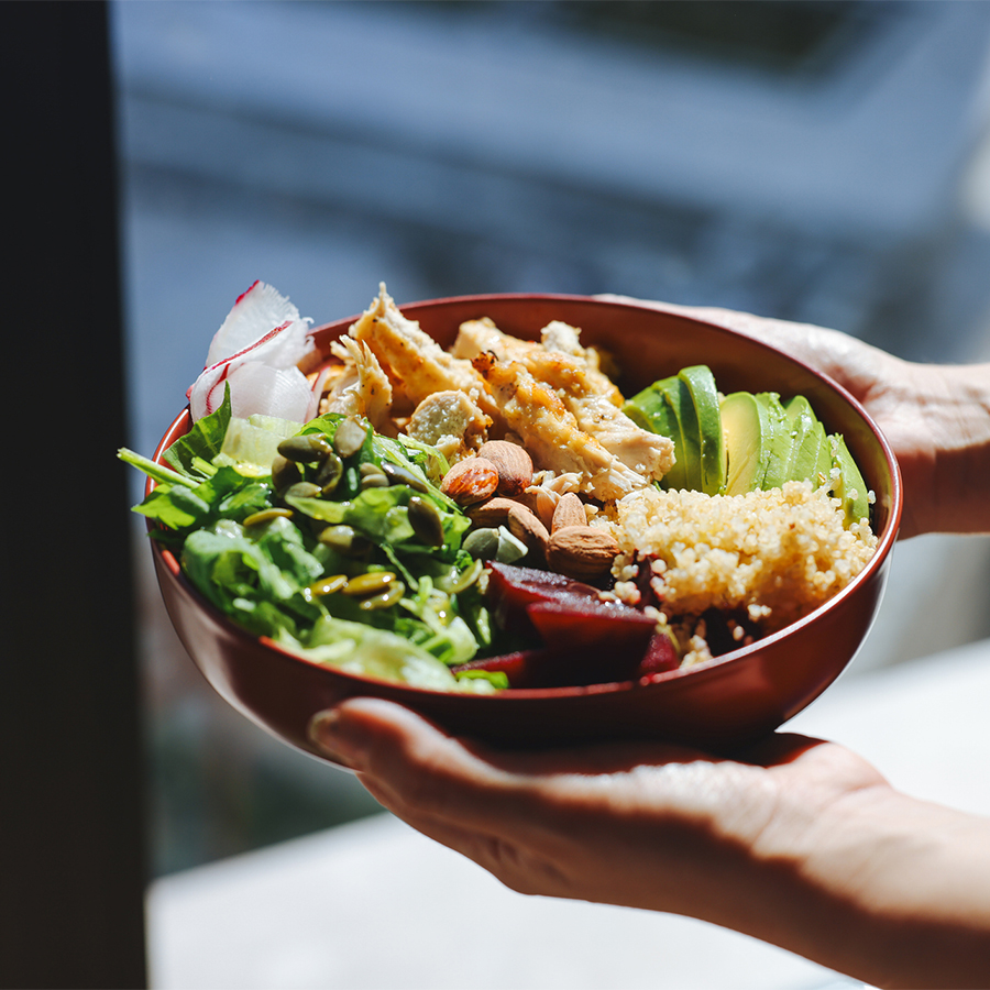 a person holding a bowl of food