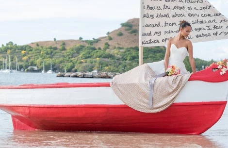 a woman in a dress sitting on a boat