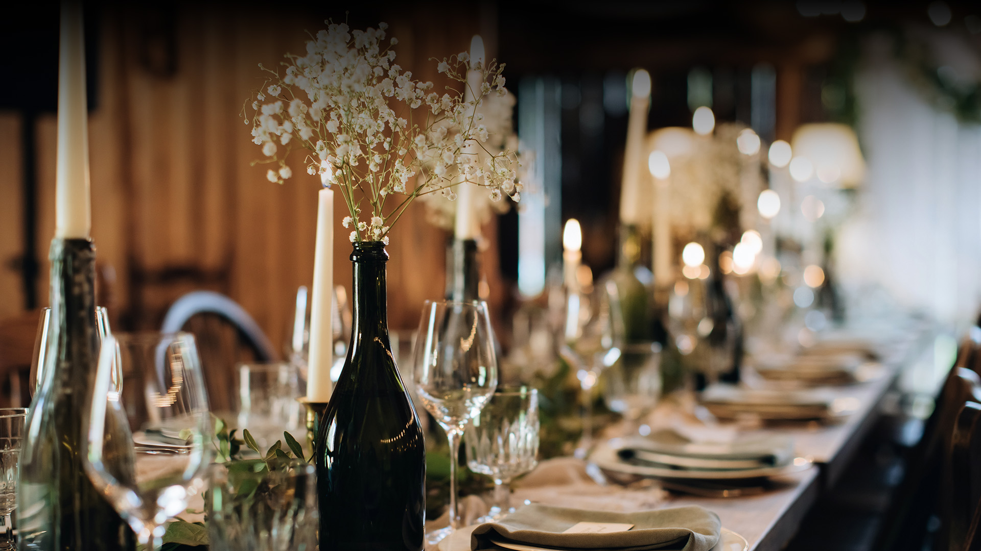 a table with wine glasses and wine bottles