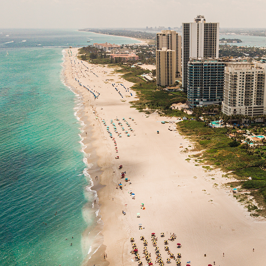 a beach with buildings and water