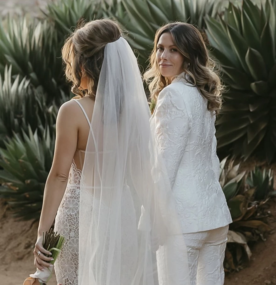 two women in white wedding attire