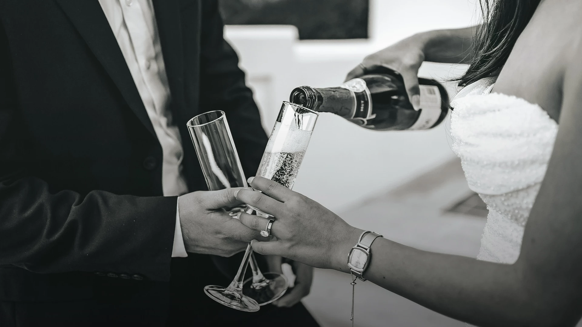 a man and woman pouring champagne into a glass