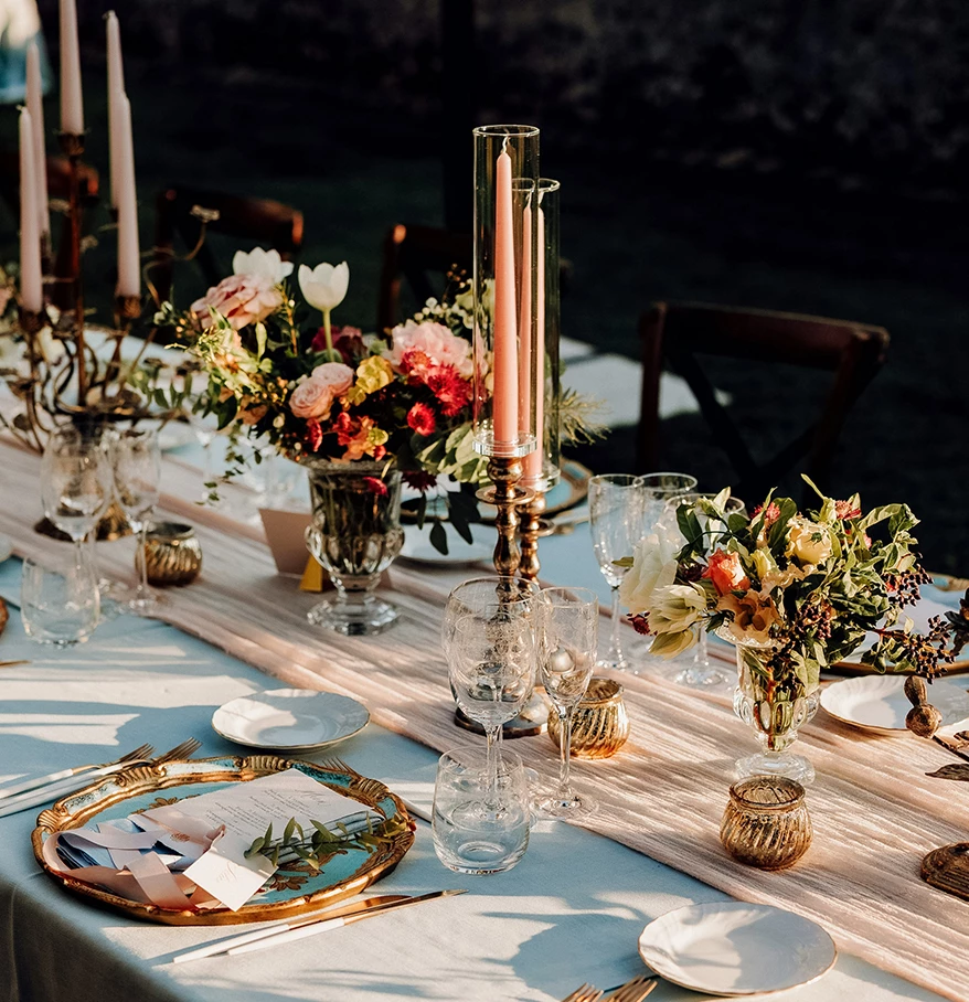 a table set with flowers and candles