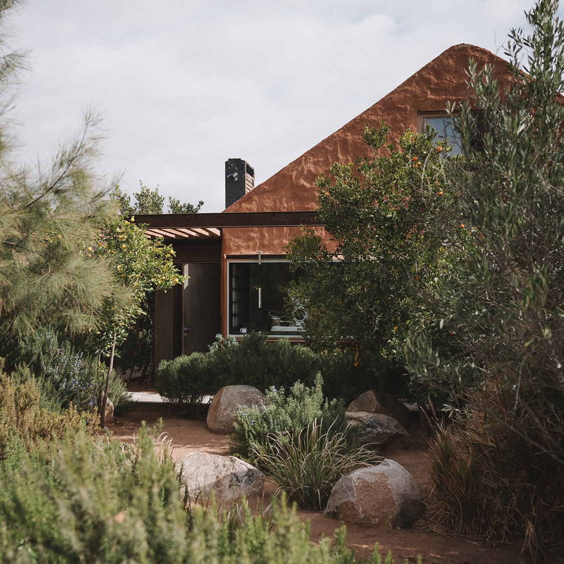 a house with a garden and rocks