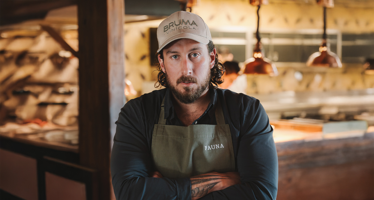 a man with a beard wearing a hat and apron