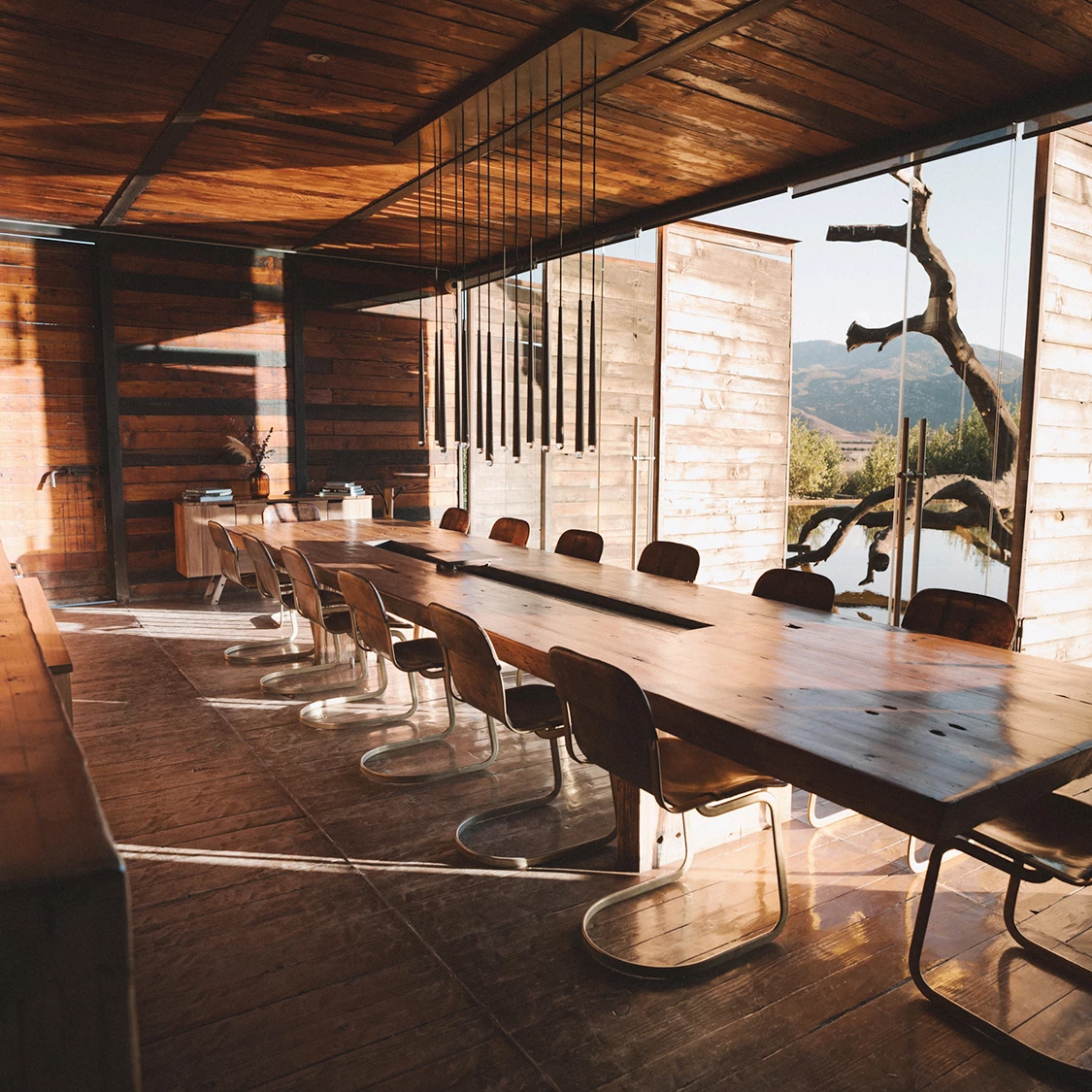 a room with a long table and chairs