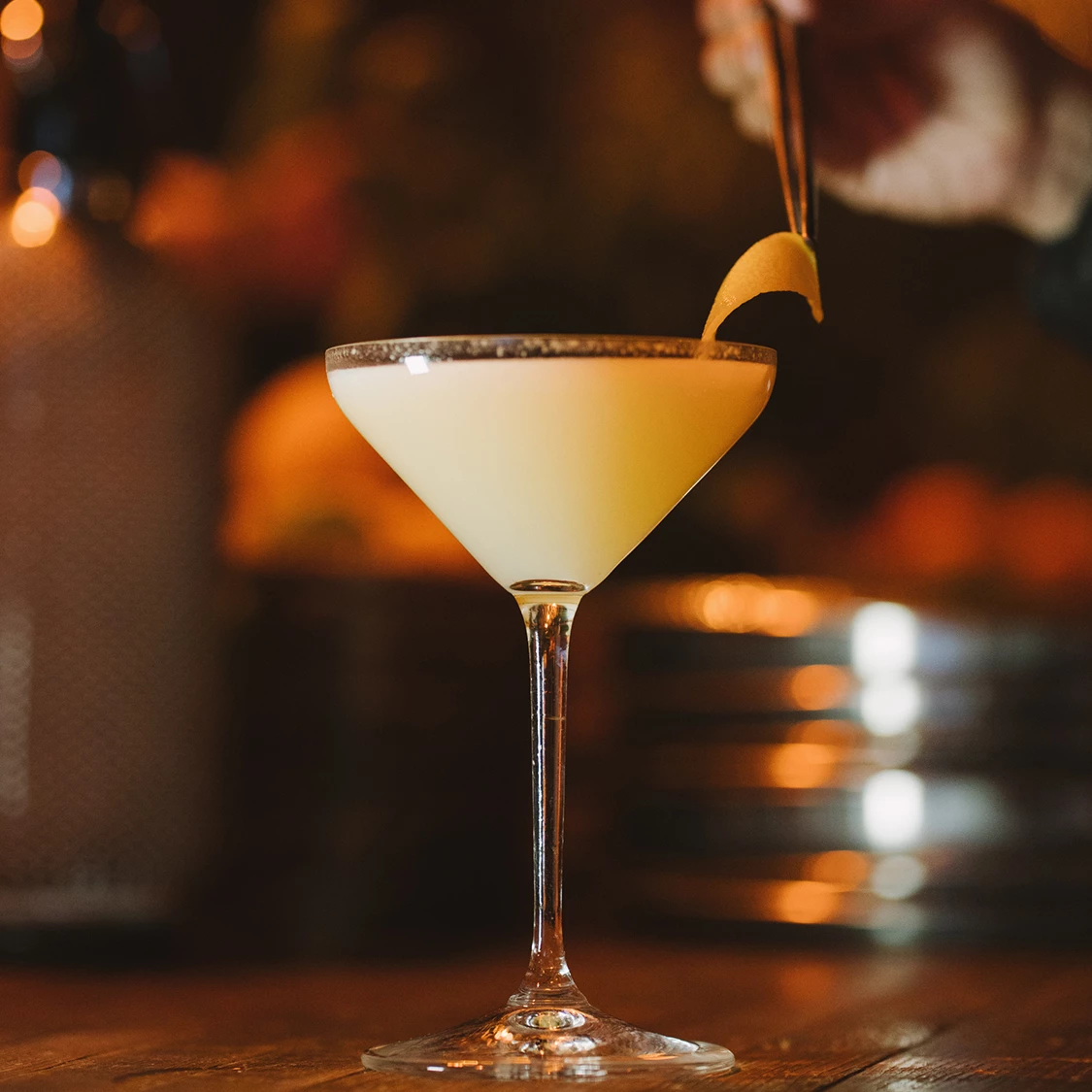 a glass with a drink and a lemon wedge
