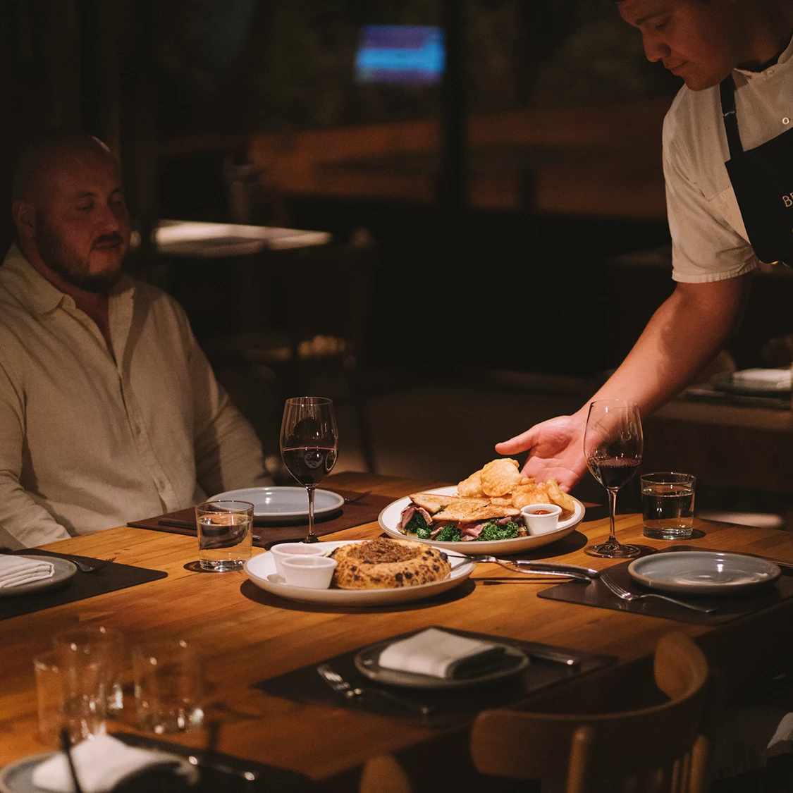 a man serving food at a table