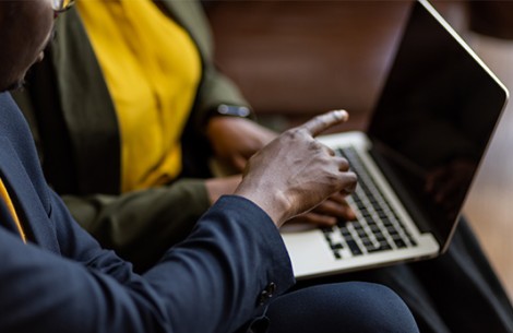 a man and woman using a laptop