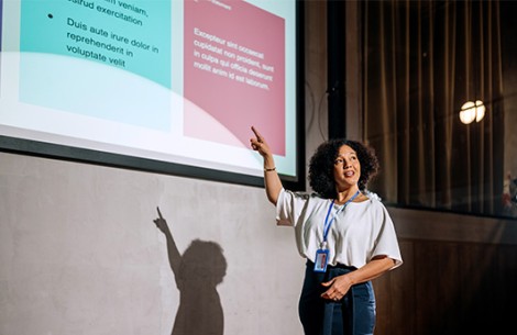 a woman pointing at a projector screen