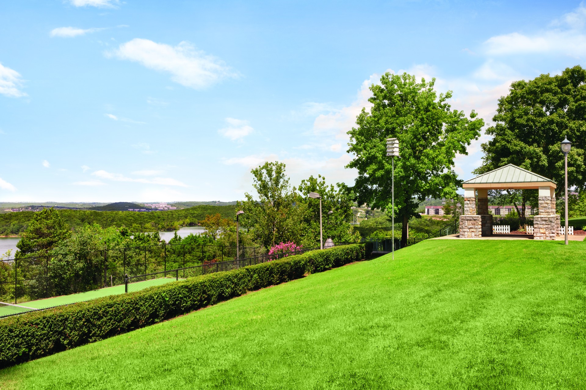 a building with a stone structure on a grassy hill