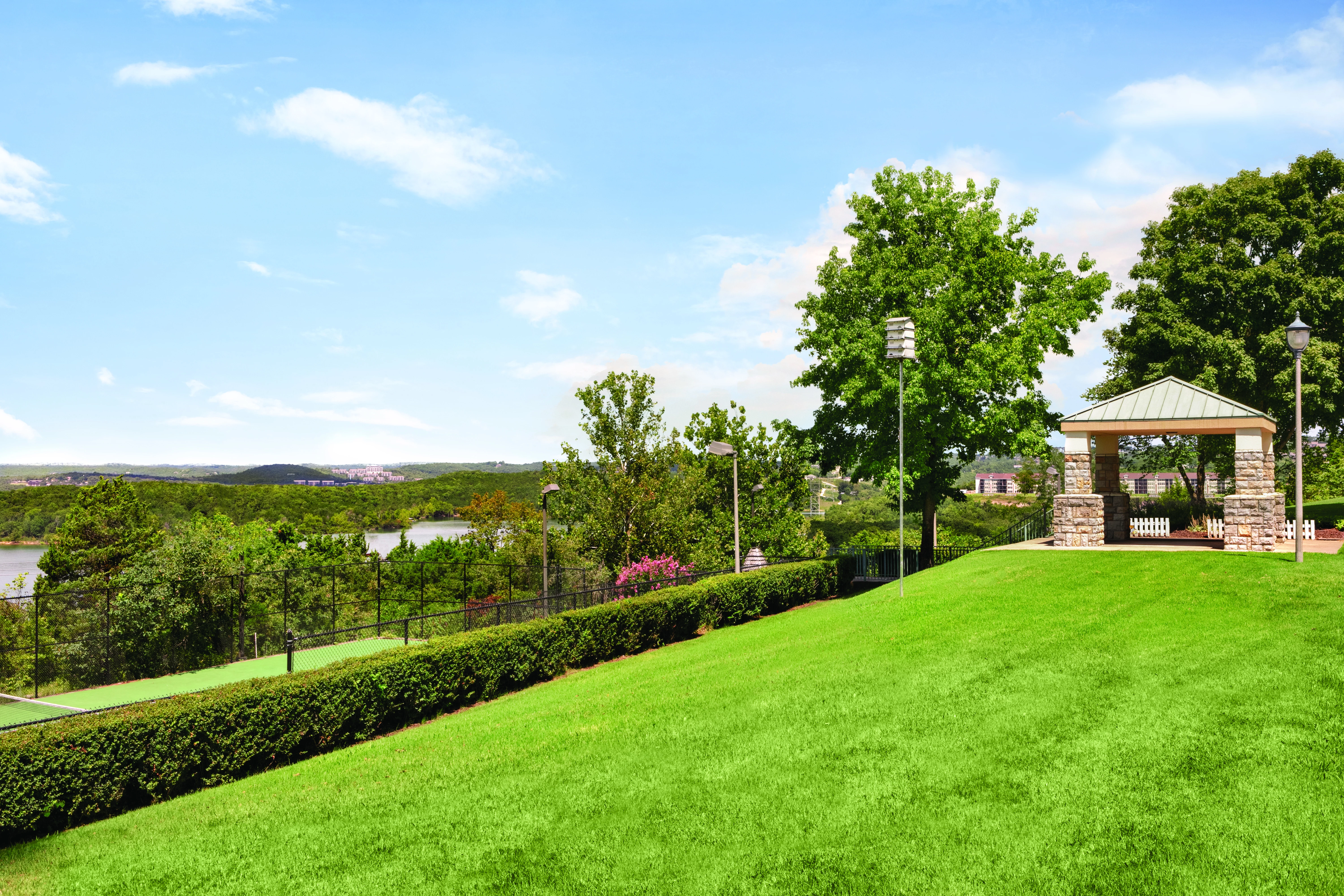 a building with a stone structure on a grassy hill