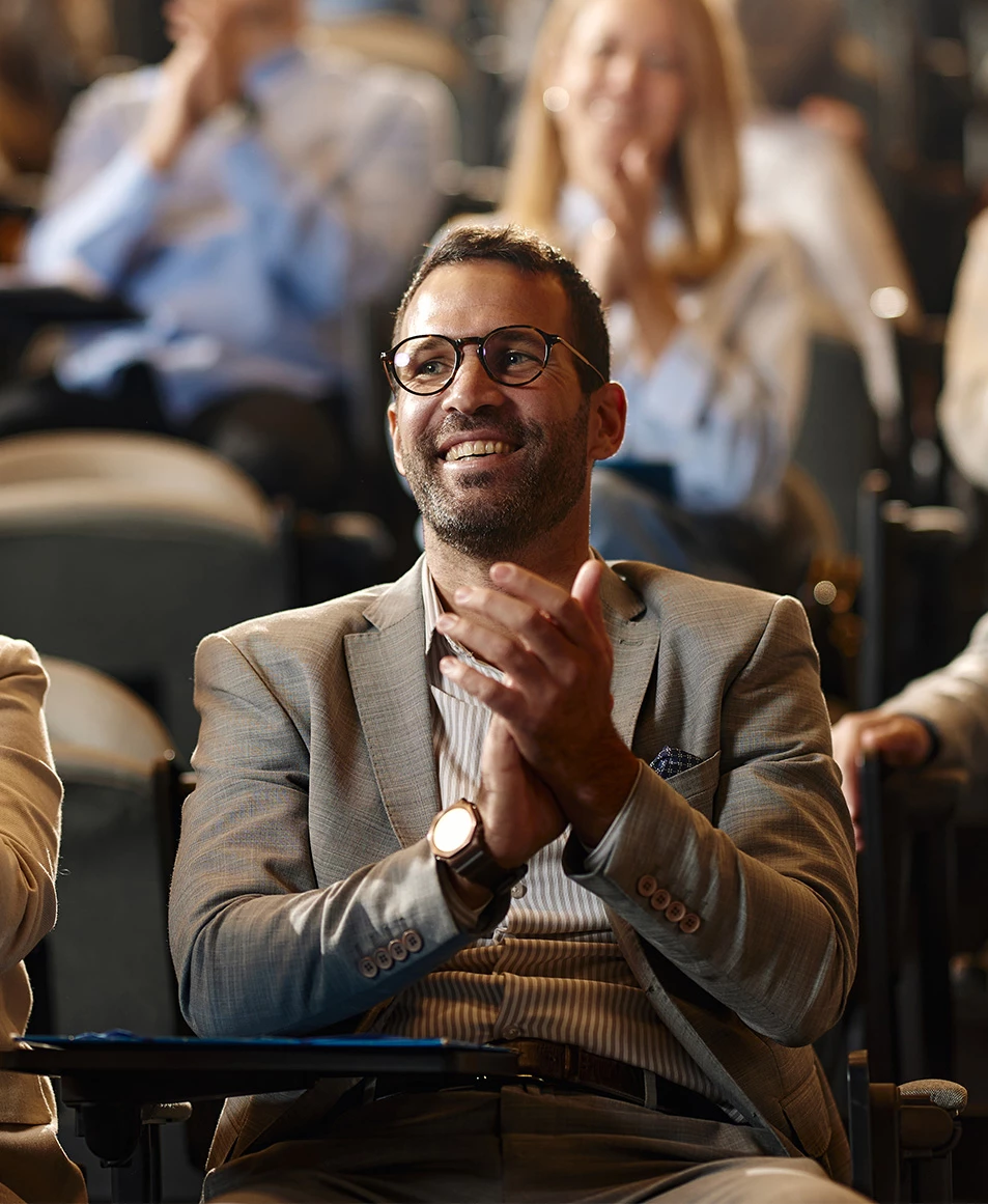 a man in a suit and glasses smiling