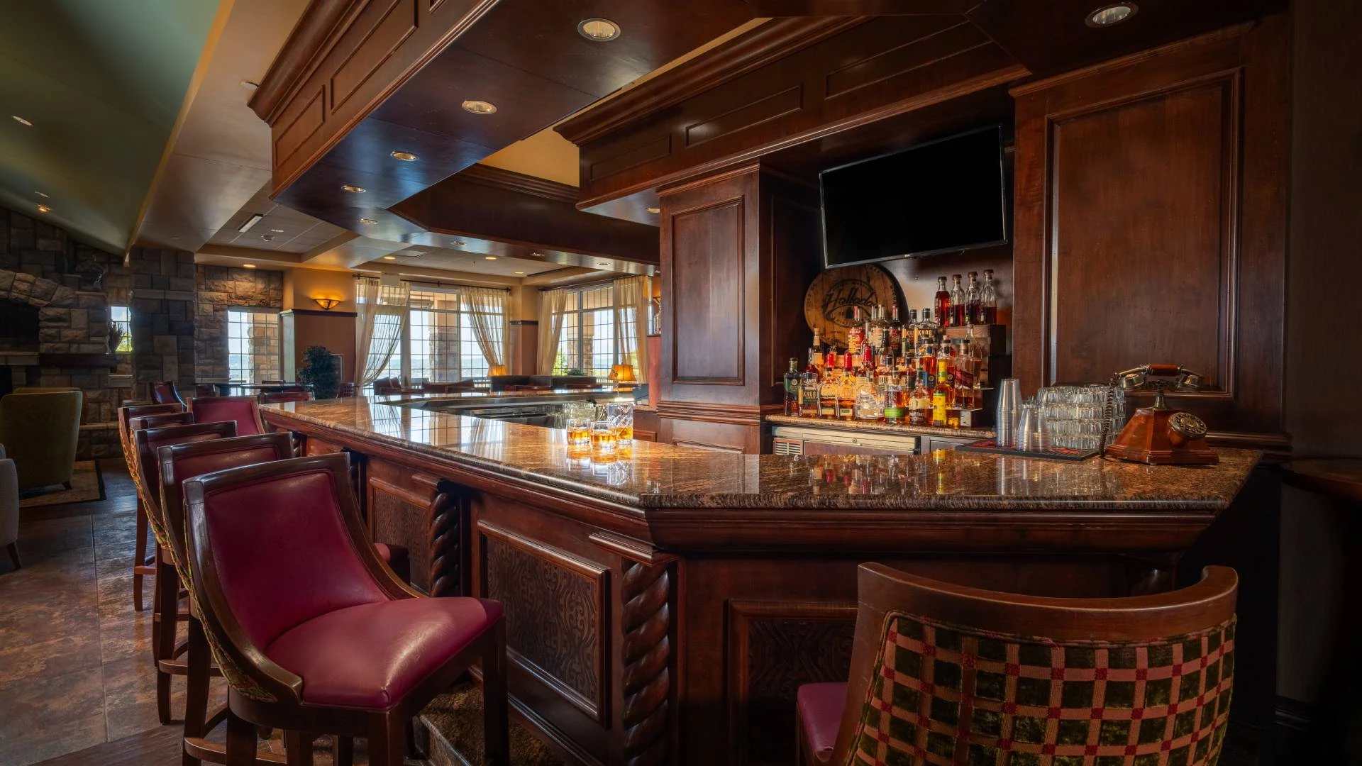 a bar with a counter and chairs
