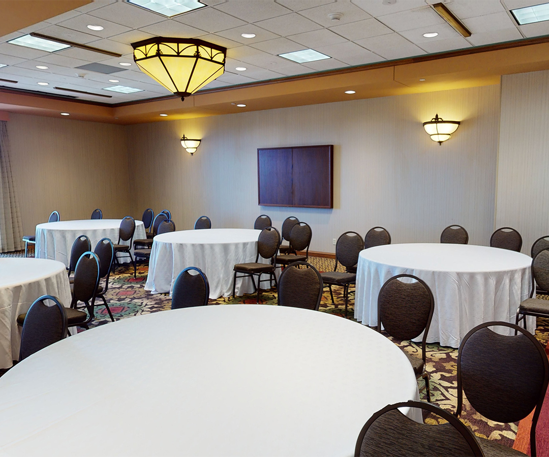 a room with round tables and chairs