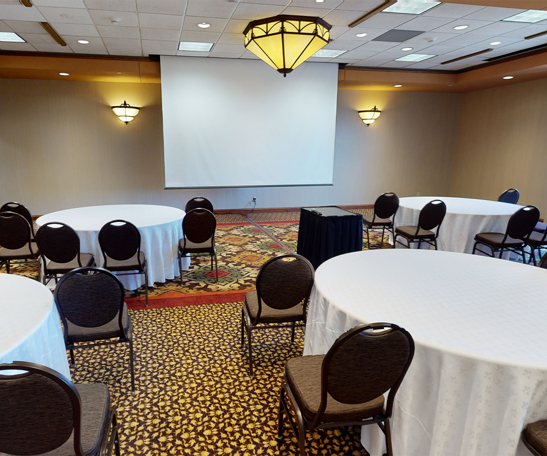 a room with round tables and chairs