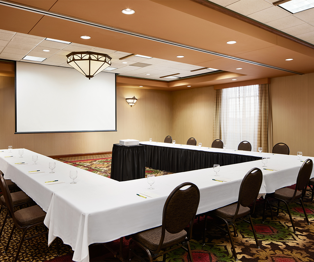 a room with a large table and chairs