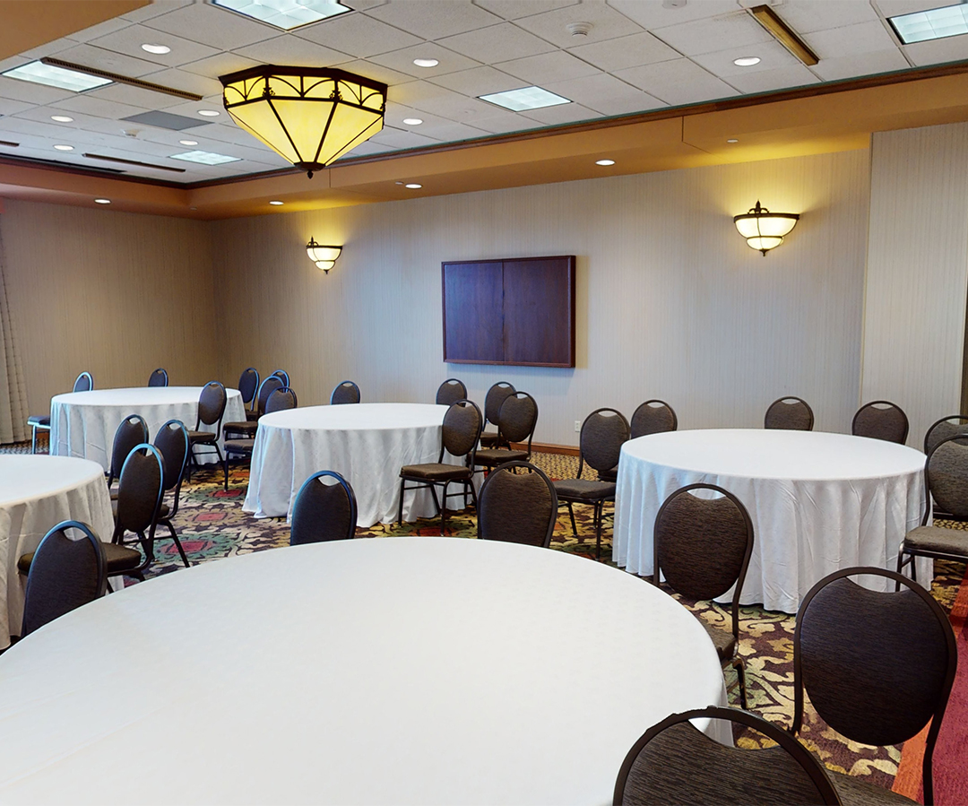 a room with round tables and chairs