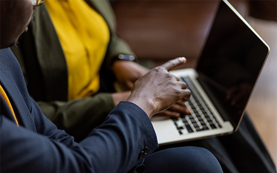 a man and woman using a laptop