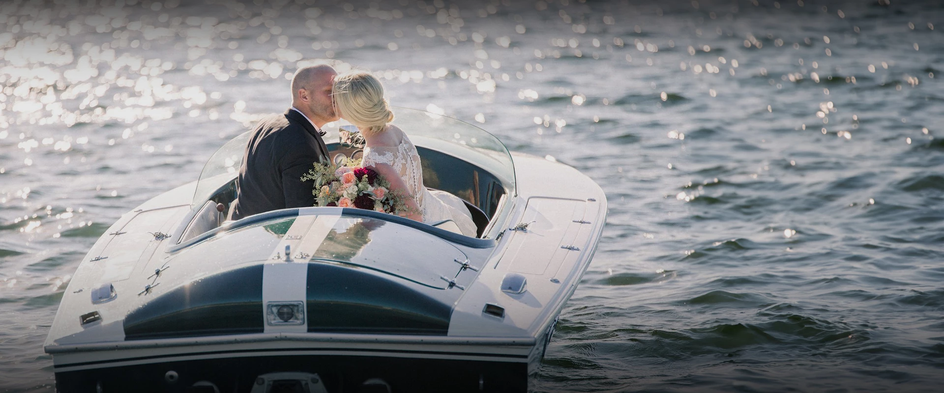 a man and woman kissing in a boat