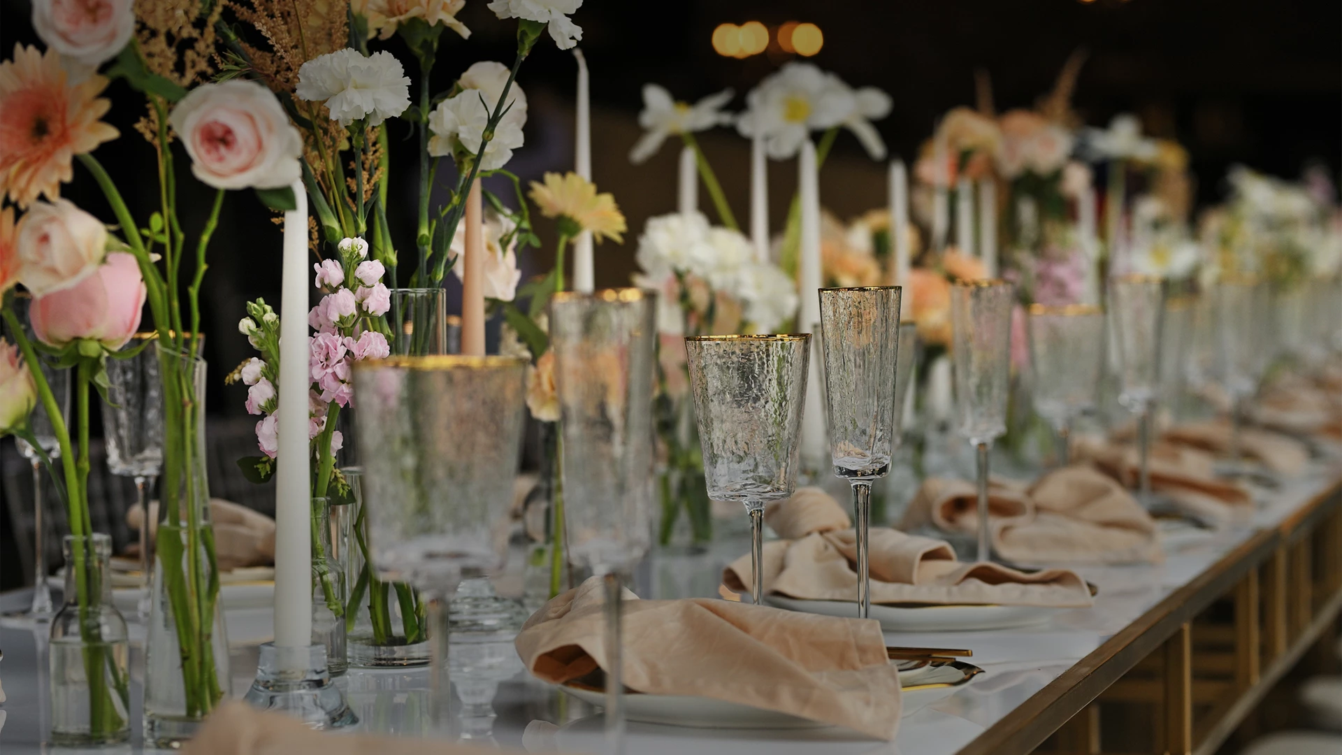 a table with glasses and flowers