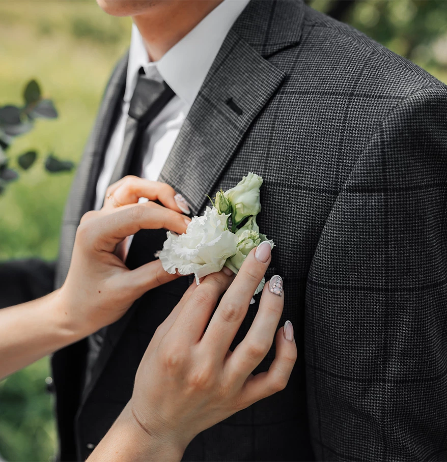 a person wearing a suit with a flower on the lapel